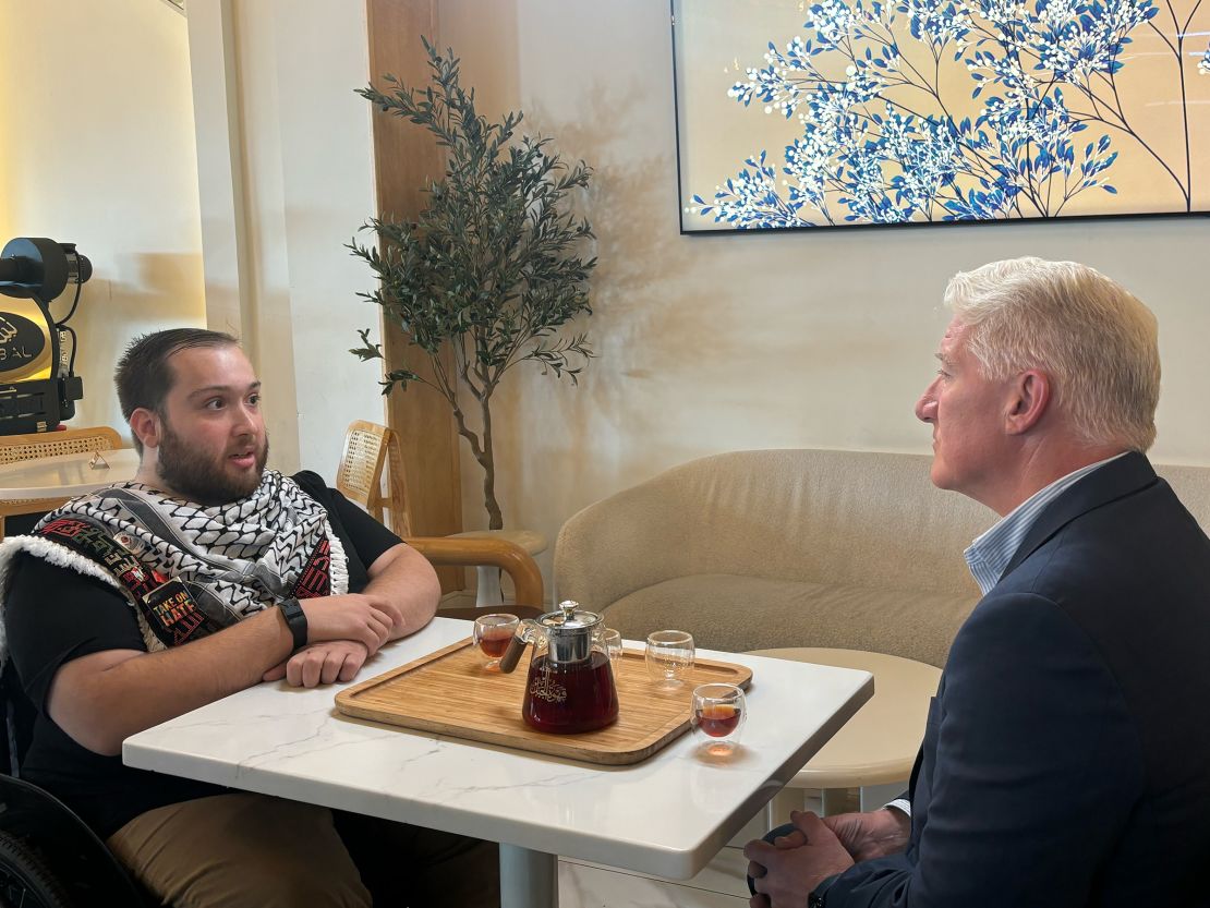 Wayne State student Wahbeh Nuseibeh talks with John King in Dearborn, Michigan.